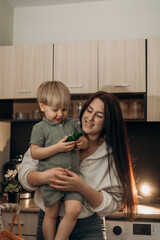 Little boy stirs flour with full attention while mom guides him lovingly a real life moment full of tactile discovery learning joy and close parent child bond in a cozy kitchen atmosphere at home