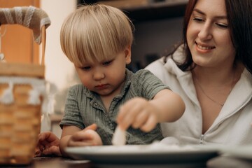 Joyful bonding in the kitchen as a toddler learns through playful flour exploration guided by a loving mother creating memories of creativity growth connection and mindful parenting through fun