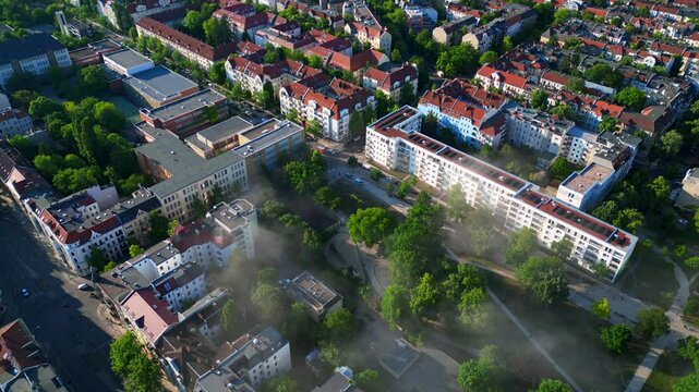 Rescue helicopter landing in Berlin urban park. Magic aerial view flight drone