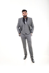 A man in an elegant gray suit with a tie and watch, a stylish business look on a white background.