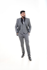 A man in an elegant gray suit with a tie and watch, a stylish business look on a white background.