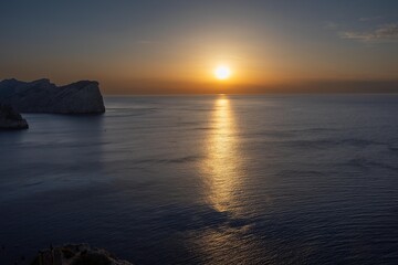 Fototapeta premium Golden sunset illuminating calm mediterranean sea at cap de formentor, majorca