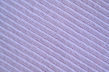 purple texture of knitted synthetic fabric as a background, pink smooth symmetrical lines of synthetic fabric