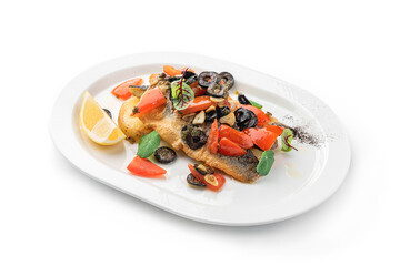 Baked fillet dorado fish with grilled vegetables, lemon and olives in plate isolated on white background. Seafood, top view, close up
