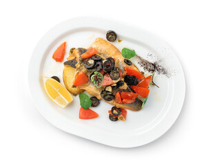 Baked fillet dorado fish with grilled vegetables, lemon and olives in plate isolated on white background. Seafood, top view, close up
