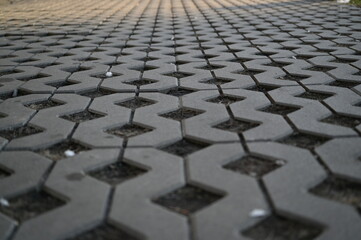 Background texture of square tiles made of gray natural stone. Concrete street covering of road,...