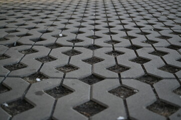 Background texture of square tiles made of gray natural stone. Concrete street covering of road,...