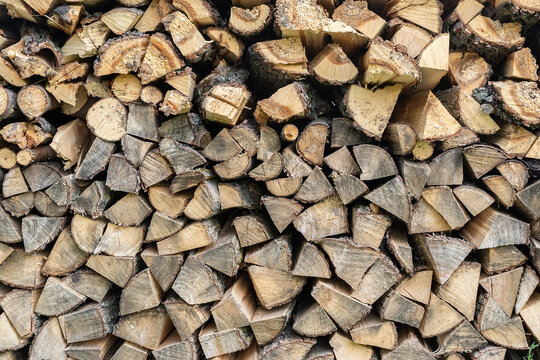 Stacked wood piles or firewood close up or texture or background.
