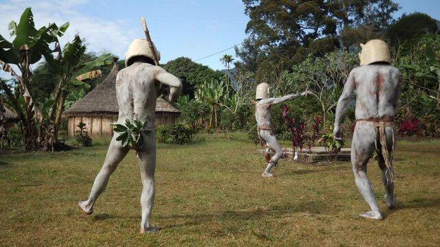 Asaro Mudmen tribe bow hunting. Papuan tribe dance. Mount Hagen tribe festival. Cultural event. Indigenous men in native costumes. High quality 4k footage