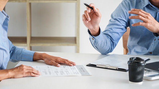 Interviewer or Board reading a resume during job interview, Employer interviewing a young male job seeker for recruitment talking in modern office and filing card, employment and recruitment concept