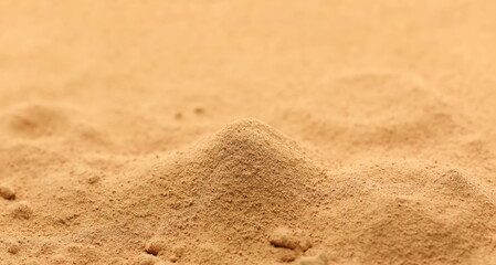 Red maca organic powder pile background and texture, side view	