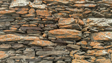 Stones in facade decoration. Layers and cracks in stone.