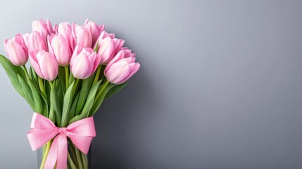 Obraz premium Beautiful Pink Tulips Bouquet with Ribbon on Gray Background
