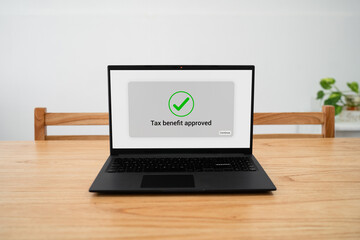 Fototapeta premium Tax benefit approved message on laptop screen. Concept of applying for tax deductions through your computer.