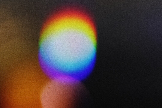 Blur colorful rainbow crystal light leaks on black background. Defocused abstract multicolored retro film lens flare bokeh analog photo overlay or screen filter effect. Glow Vintage prism colors