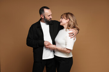 Portrait of lovely couple on brown background