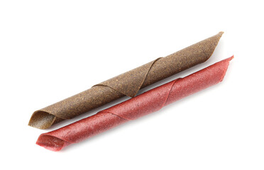 Delicious fruit leather rolls on white background, top view