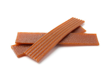 Pieces of delicious fruit leather on white background