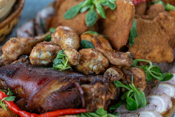 Close-up of chicken feet on a meat platter.
