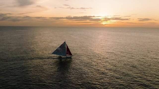Beautiful landscape of paraw private sailing boat with sunset background in Boracay, Philippines.