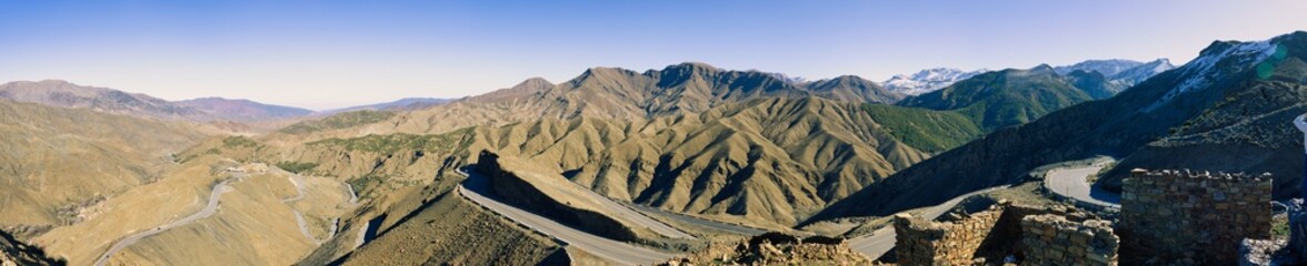 Arid mountain valley with village and road.