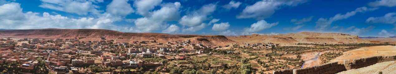 Desert town, terracotta buildings, arid landscape.
