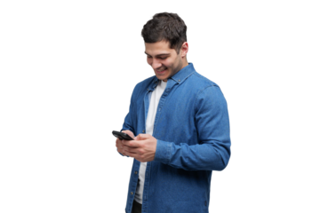 Young man smiling while using smartphone in a casual blue denim shirt, in a bright minimalist setting