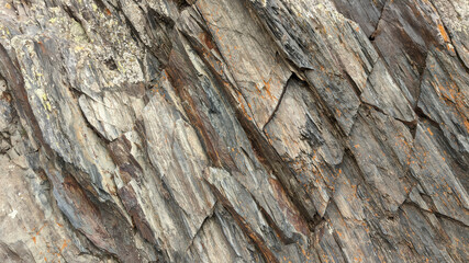 Background of layers and cracks in rock. Natural stone background or stone texture.