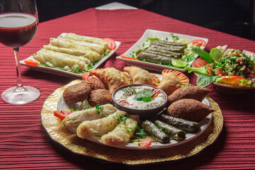An exquisite assortment of Middle Eastern cuisine including stuffed grape leaves, falafel, and savory salads, creating an inviting spread for sharing and enjoying.