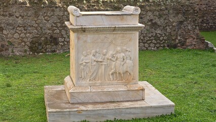Pompeii, Italy - 8 January 2025. Marble altar with carved sacrificial scene, located in front of the Temple of Vespasian at the archaeological site.