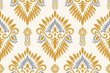 Traditional ikat pattern seamless textile design in yellow and blue color scheme. Ethnic bohemian fabric ornament for fashion, home decor, crafts, wallpaper, wrapping paper, and surface design.