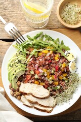 Tasty salad with brown rice served on wooden table, flat lay