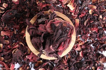 Hibiscus tea. Wooden bowl with dried roselle sepals on table, top view