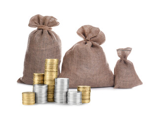 Wealth. Stacked coins and burlap bags isolated on white