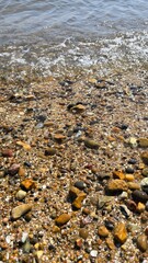 Beach pebbles and ocean water scenic view for summer travel background