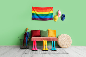 Interior of hall with bench, gumboots and LGBT flag