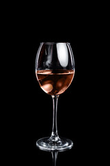 The glass of rose wine on a black background