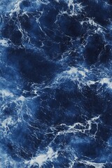 Close-up view of turbulent ocean waves. Deep blues and white froth