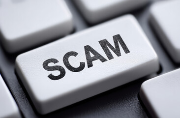 Close up of keyboard key labeled SCAM, highlighting importance of online safety and awareness against fraud