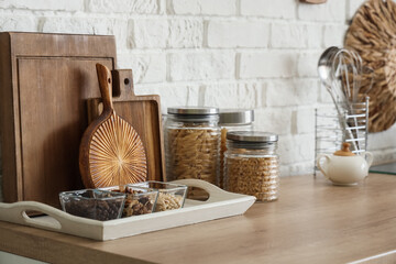 Cutting boards with food on counter near white brick wall in kitchen