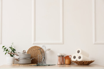 Kitchen utensils on counter near light wall