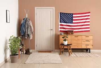 Interior of hallway with USA flag, door and military clothes
