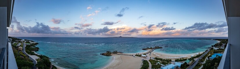 Obraz premium Panoramic View of Emerald Beach and Island at Sunset, Okinawa, Japan