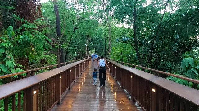 Video of a mother at Mumbai's skywalk along with her toddler. Nature trail, malabar hill, tourism, tourist, tickets, booking, online, wooden, gallery, view, sea, marine.