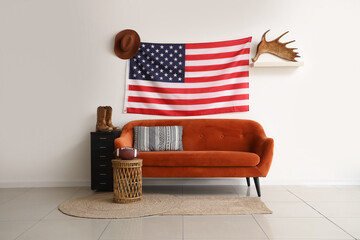 Interior of living room with USA flag, cowboy hat and sofa
