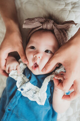 Father’s Hands Gently Holding Baby’s Cheeks with Cute Expression