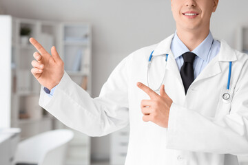 Male doctor pointing at something in clinic, closeup