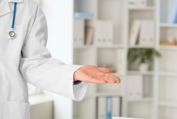 Male doctor holding something in clinic, closeup