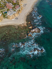aerial view of a sandy beach and sea with rocks and waves, Baja California, Mexico