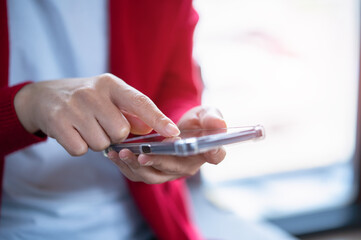 A woman playing with a mobile phone
